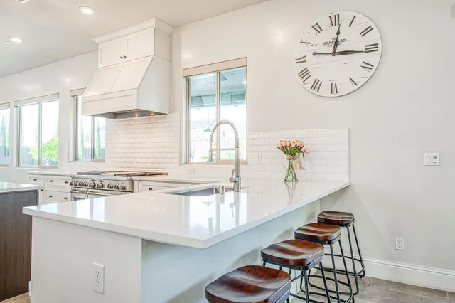 a kitchen with a stove sink and a refrigerator