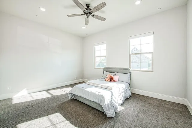 a bedroom with a large bed and a large window