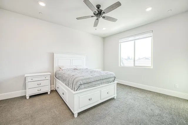 a spacious bathroom with a double vanity sink a mirror and a bathtub