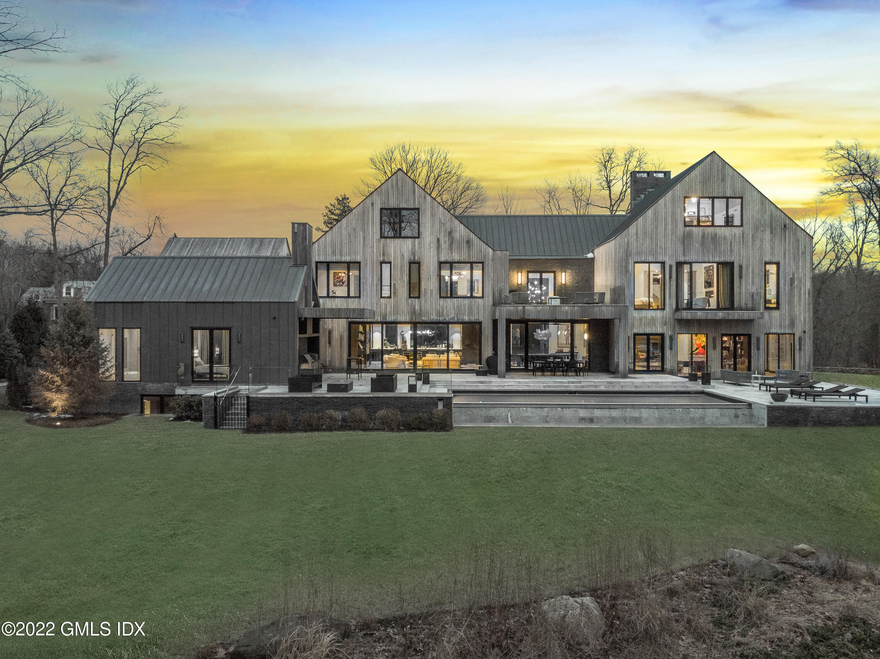 a front view of a house with swimming pool having outdoor seating
