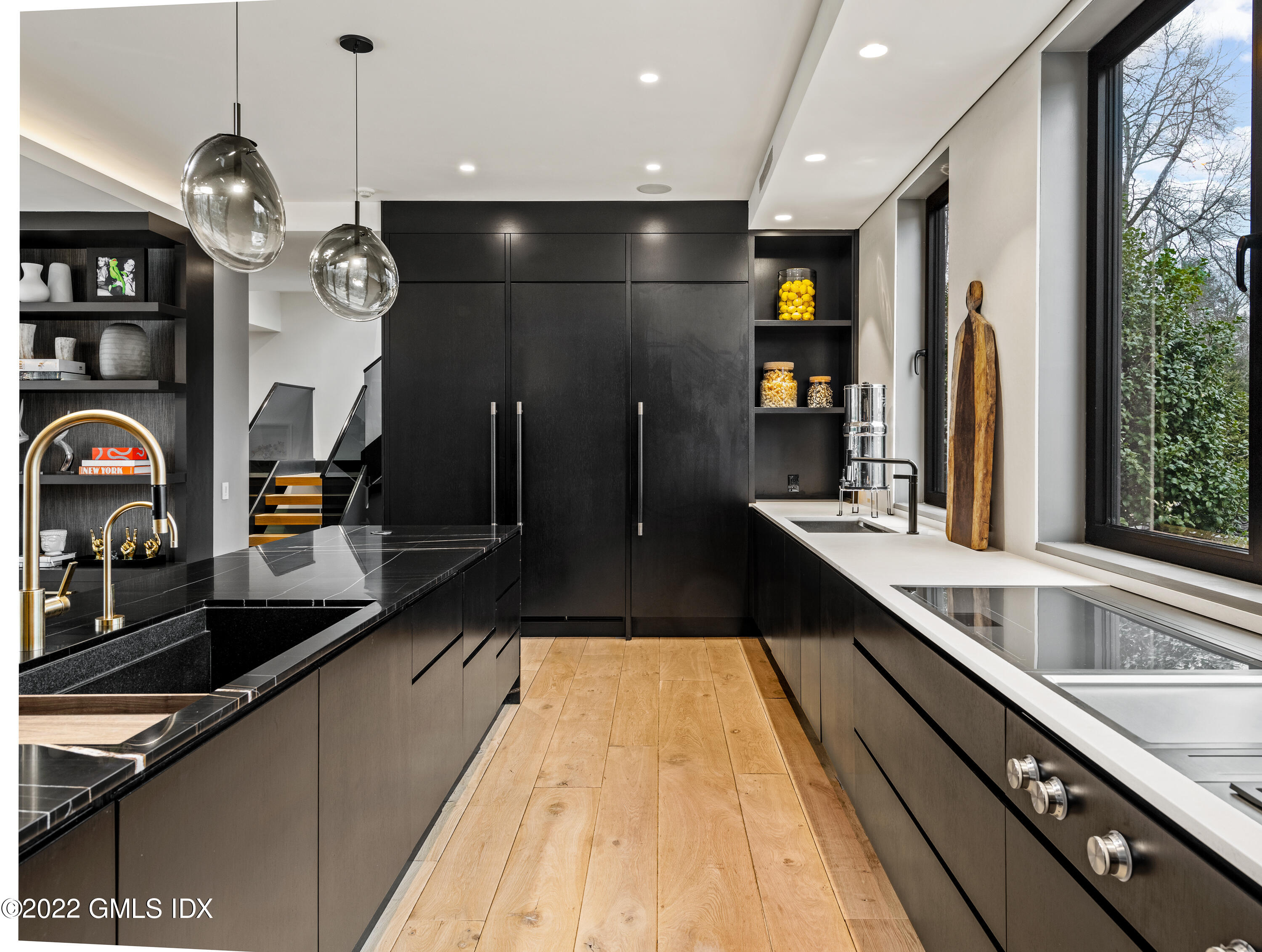 34 Beechcroft Road Greenwich, CT 06830 - Photo 13 of 25 a large kitchen with stainless steel appliances a large counter top a stove and a sink