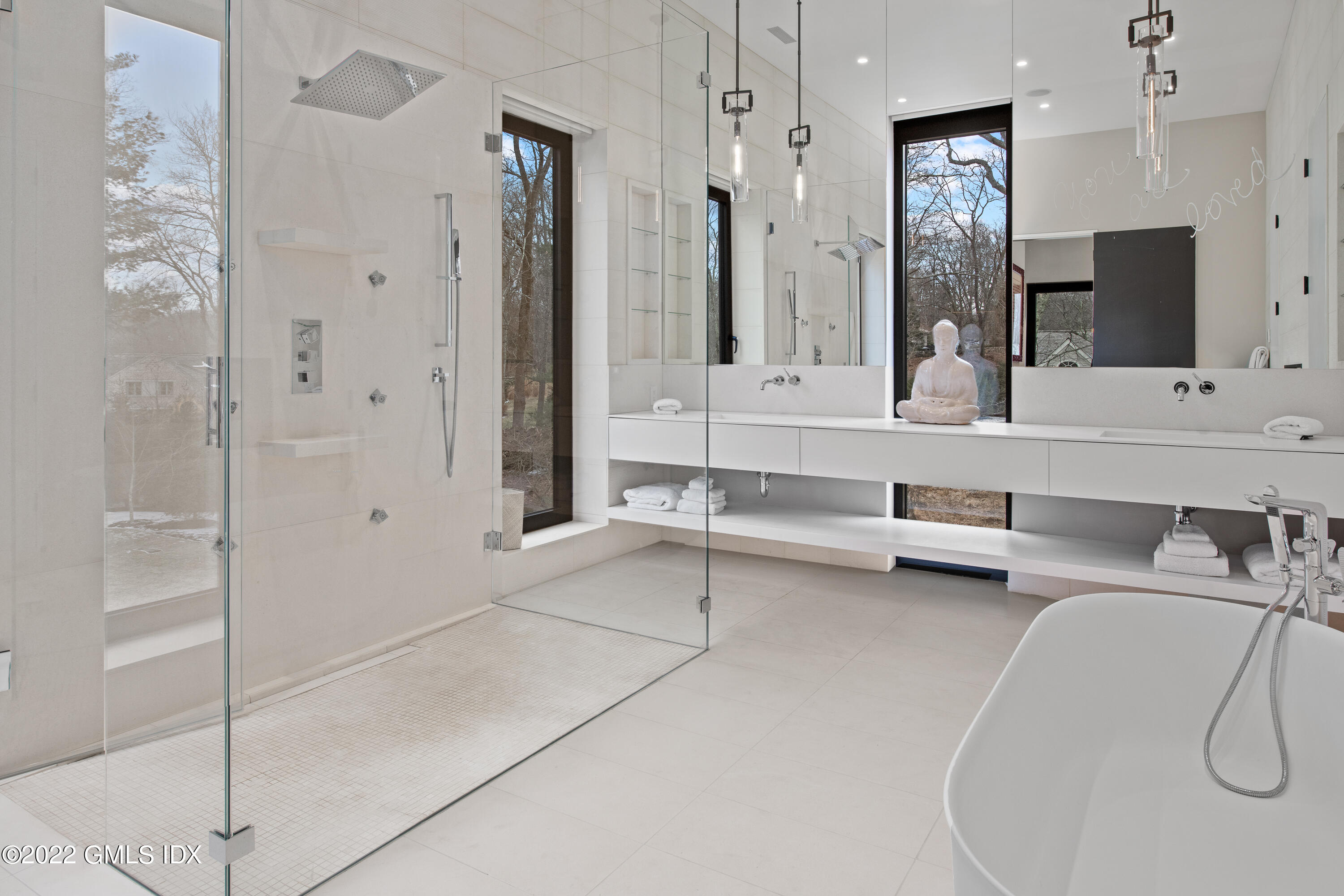 34 Beechcroft Road Greenwich, CT 06830 - Photo 19 of 25 a bathroom with a double vanity sink a mirror a bathtub and shower