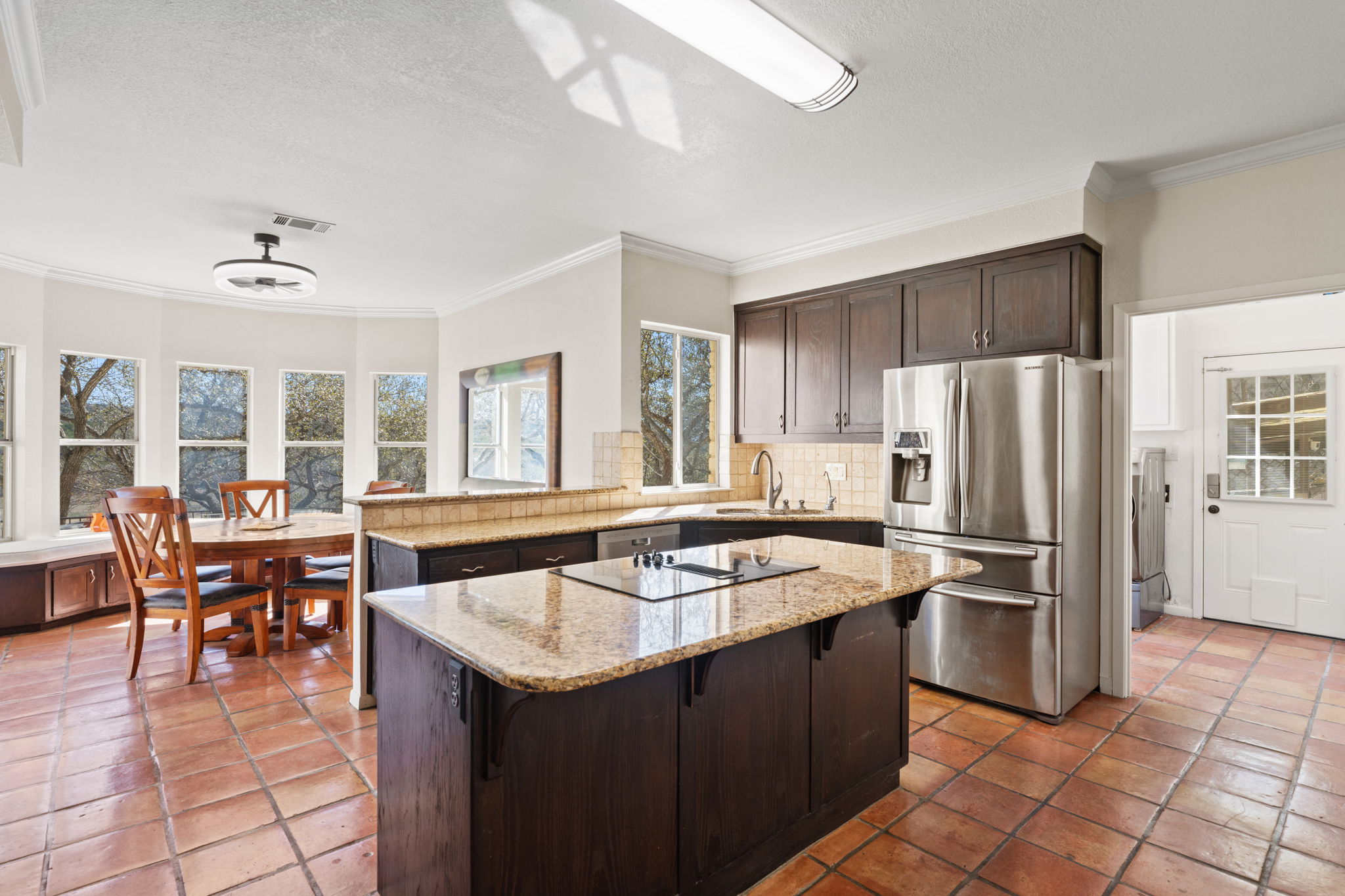 3405 Bee Creek Road Spicewood, TX 78669 - Photo 11 of 40 a kitchen with a sink a counter top space and stainless steel appliances
