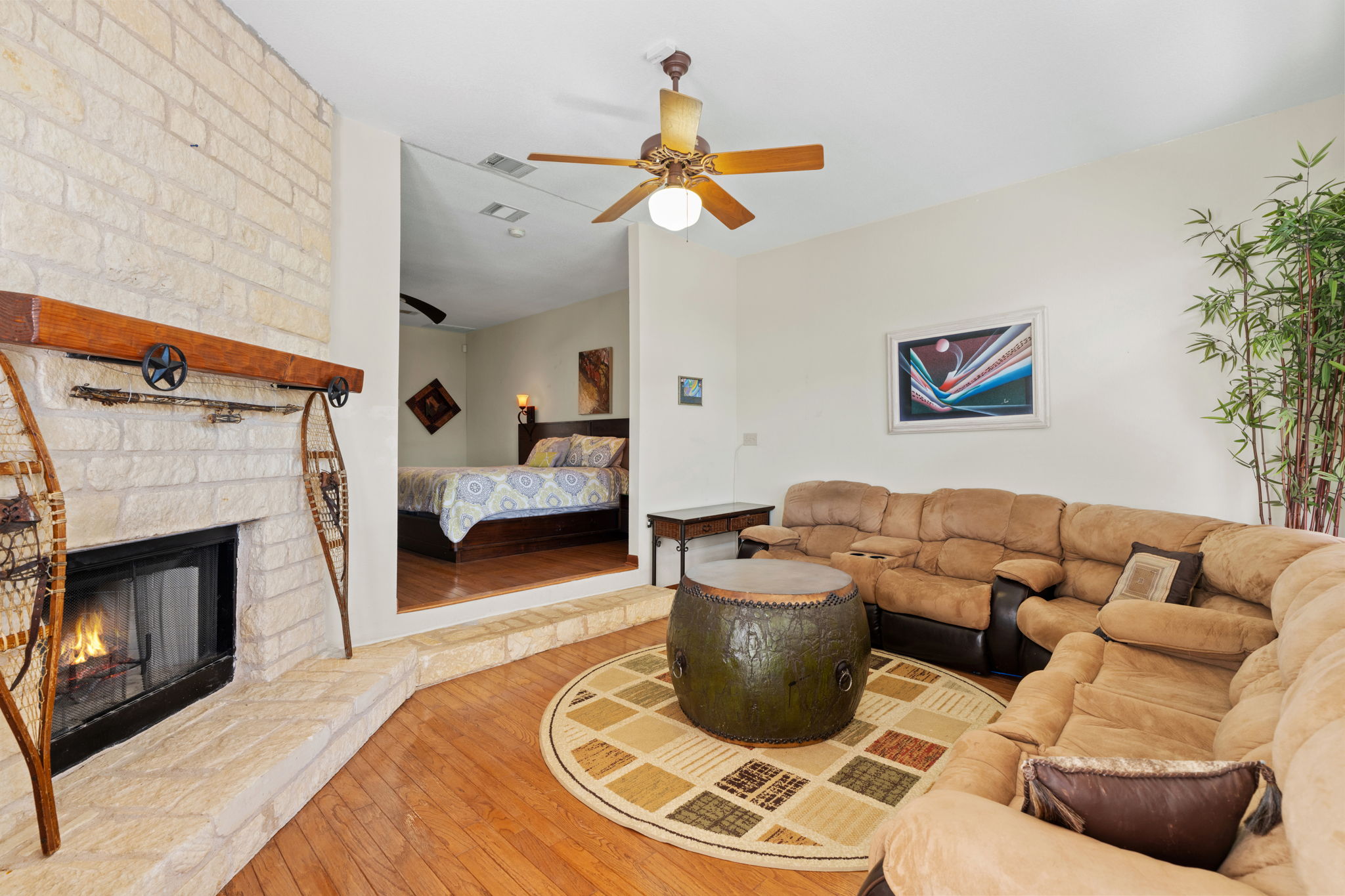 3405 Bee Creek Road Spicewood, TX 78669 - Photo 16 of 40 a living room with furniture a fireplace and a chandelier