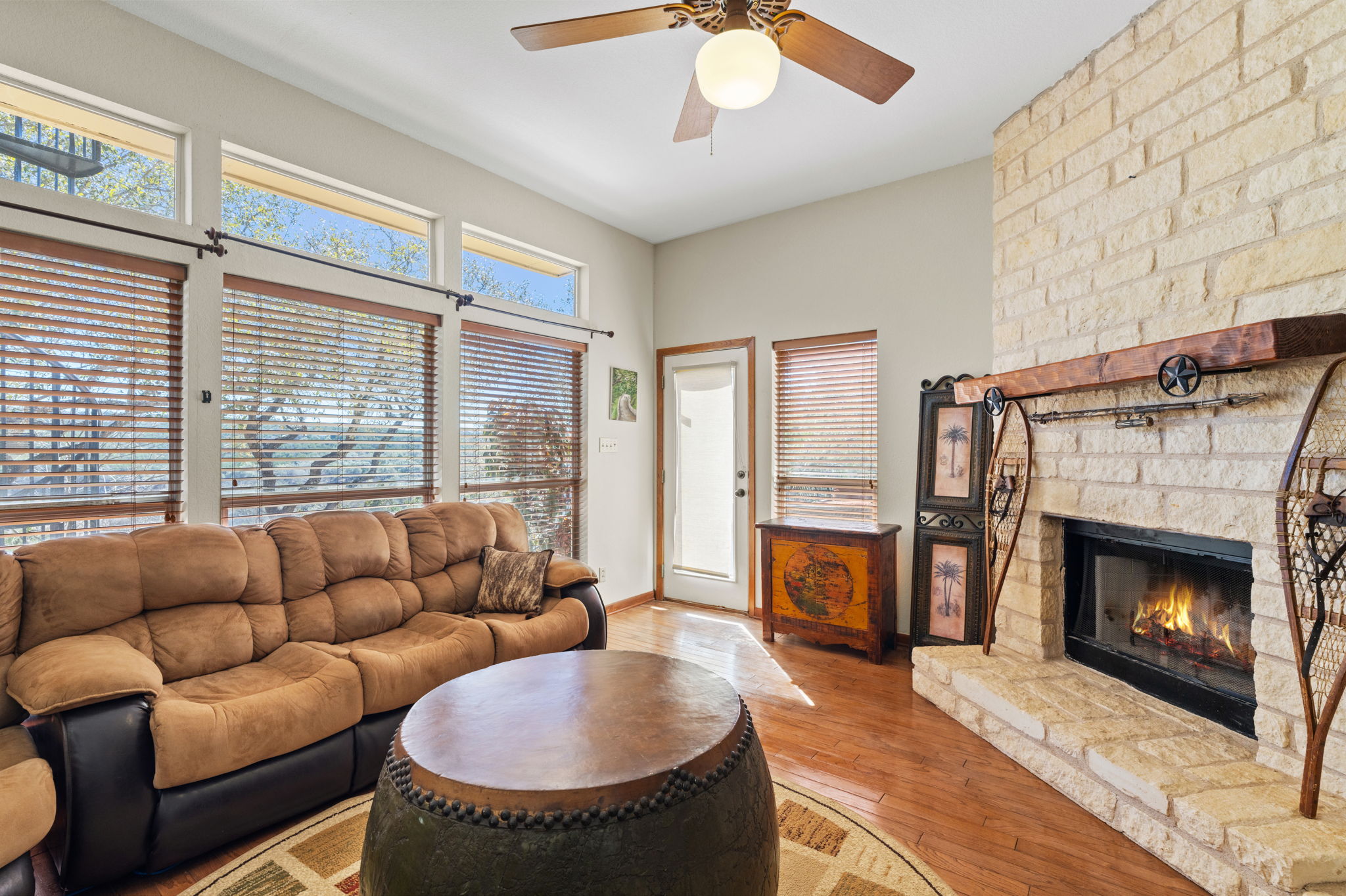 3405 Bee Creek Road Spicewood, TX 78669 - Photo 17 of 40 a living room with furniture a window and a fireplace