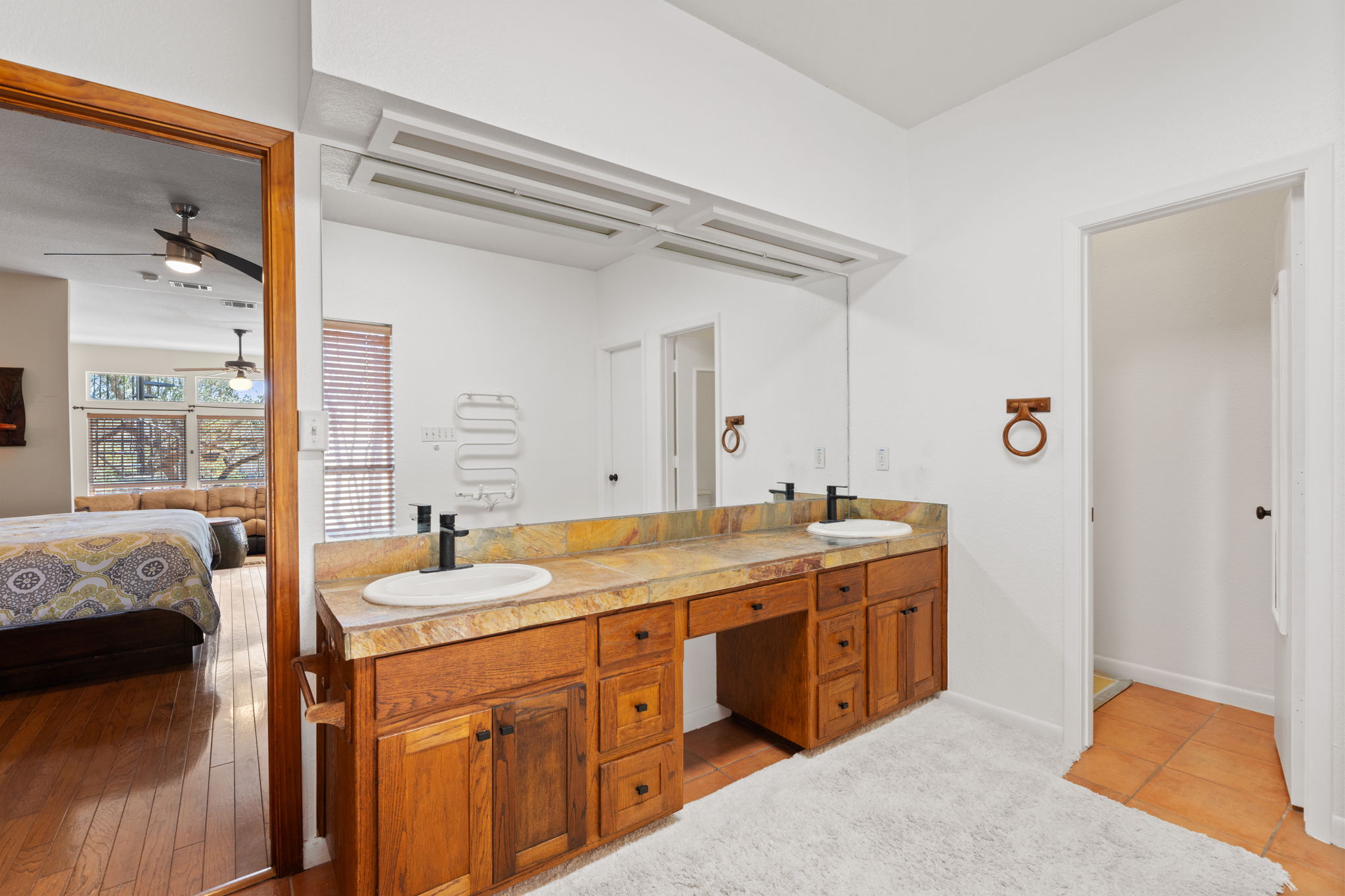 3405 Bee Creek Road Spicewood, TX 78669 - Photo 18 of 40 a spacious bathroom with a granite countertop sink and a mirror