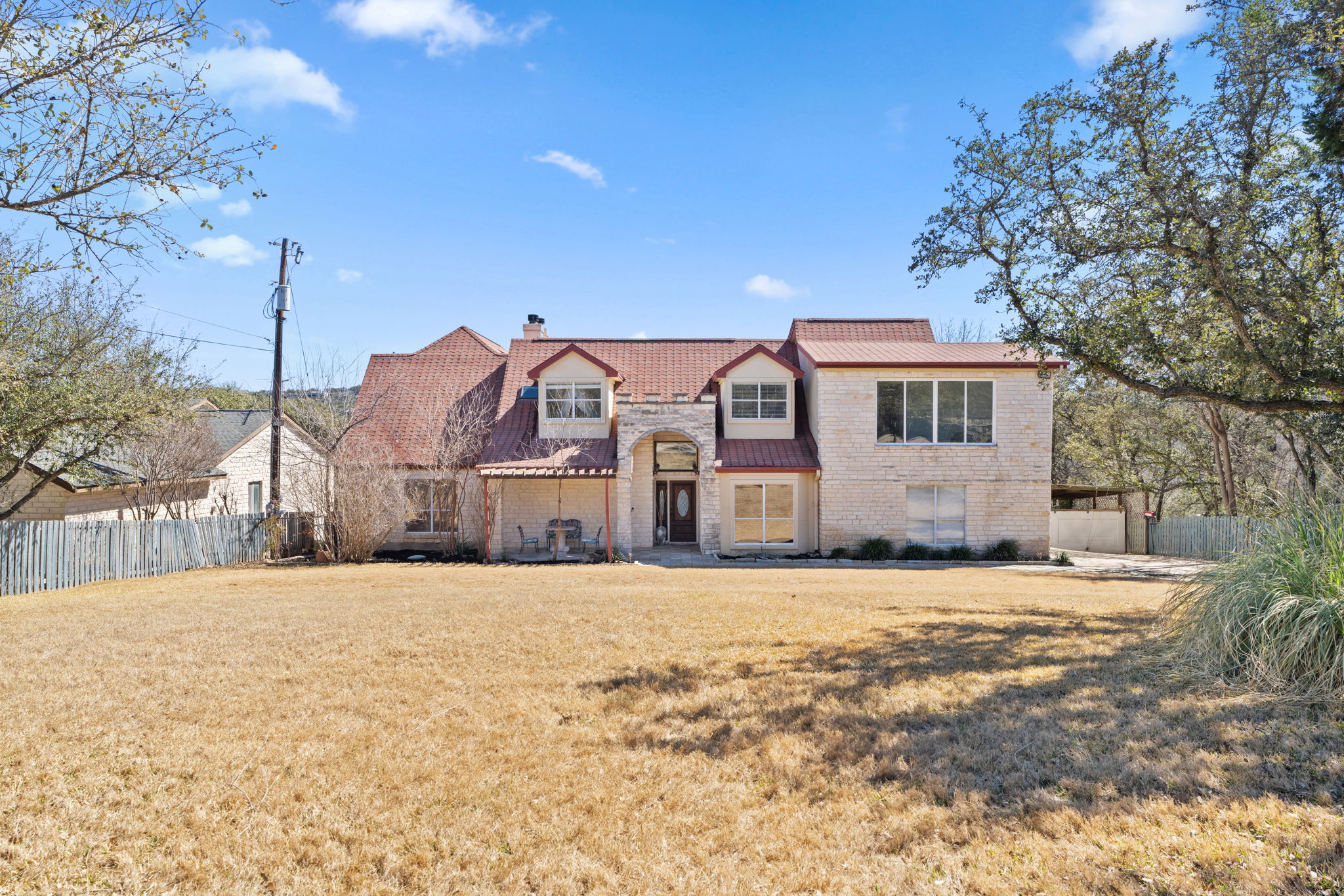 3405 Bee Creek Road Spicewood, TX 78669 - Photo 2 of 40 a front view of a house with a yard