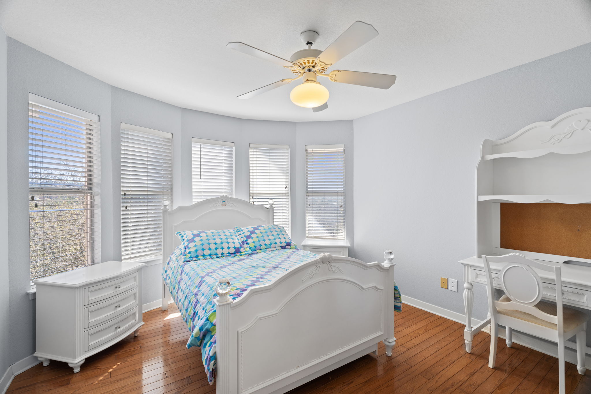 3405 Bee Creek Road Spicewood, TX 78669 - Photo 23 of 40 a bedroom with a bed and a chandelier