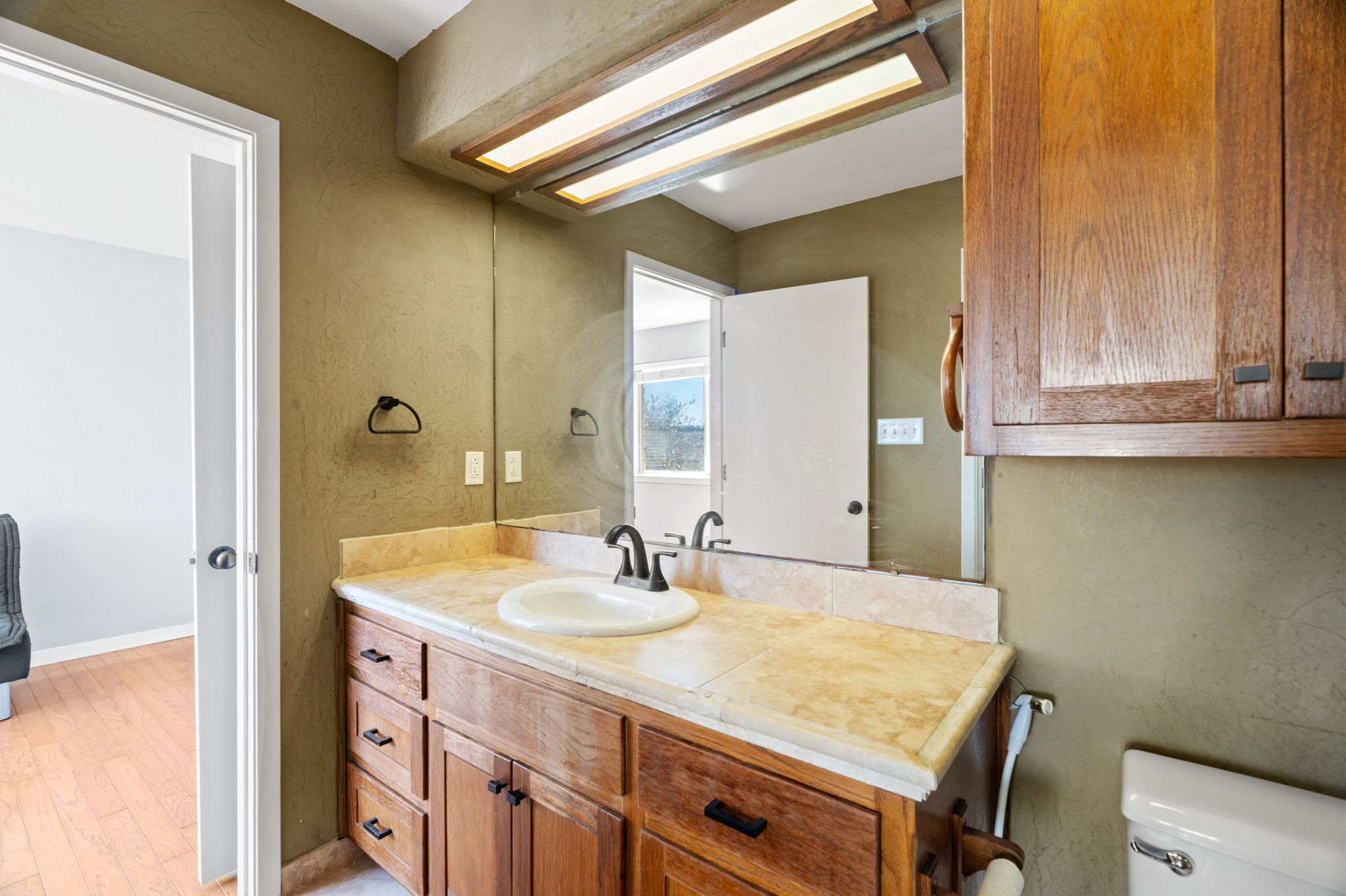 3405 Bee Creek Road Spicewood, TX 78669 - Photo 25 of 40 a bathroom with a sink and a mirror