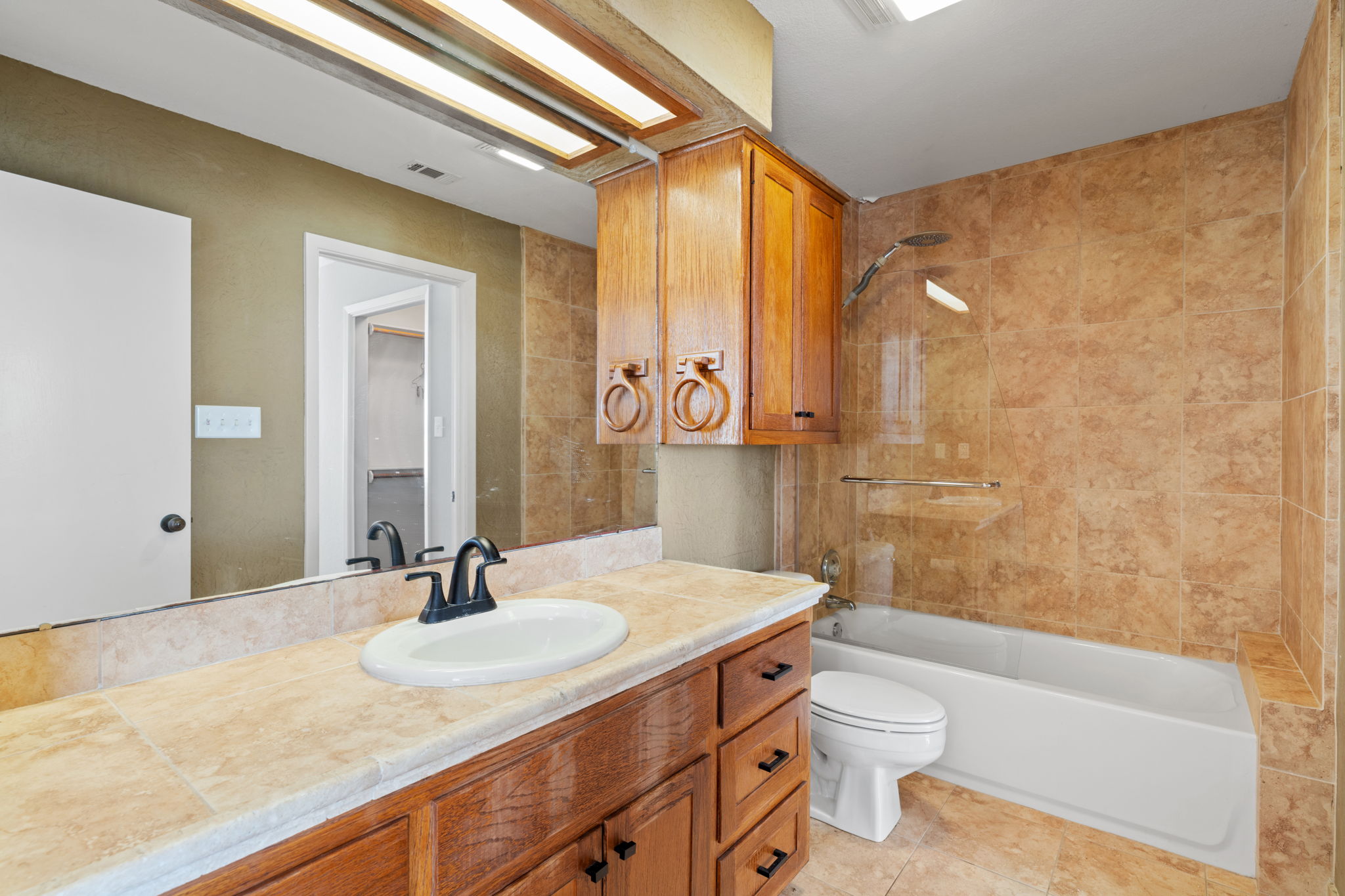 3405 Bee Creek Road Spicewood, TX 78669 - Photo 26 of 40 a bathroom with a granite countertop sink toilet and shower