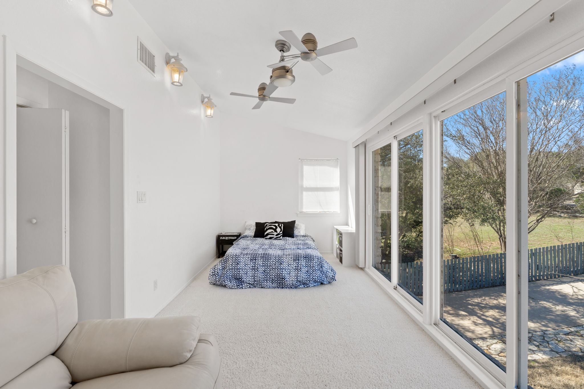 3405 Bee Creek Road Spicewood, TX 78669 - Photo 29 of 40 a bedroom with furniture and large windows