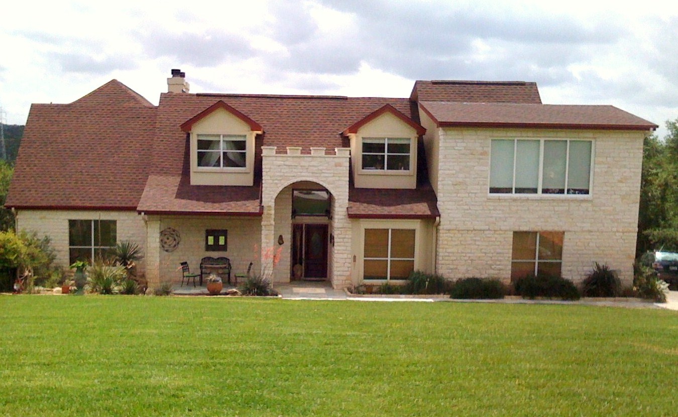 3405 Bee Creek Road Spicewood, TX 78669 - Photo 3 of 40 a front view of a house with a yard