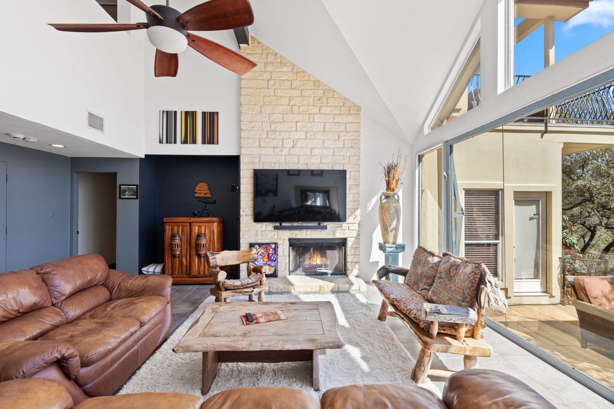 3405 Bee Creek Road Spicewood, TX 78669 - Photo 8 of 40 a living room with furniture fireplace and a flat screen tv