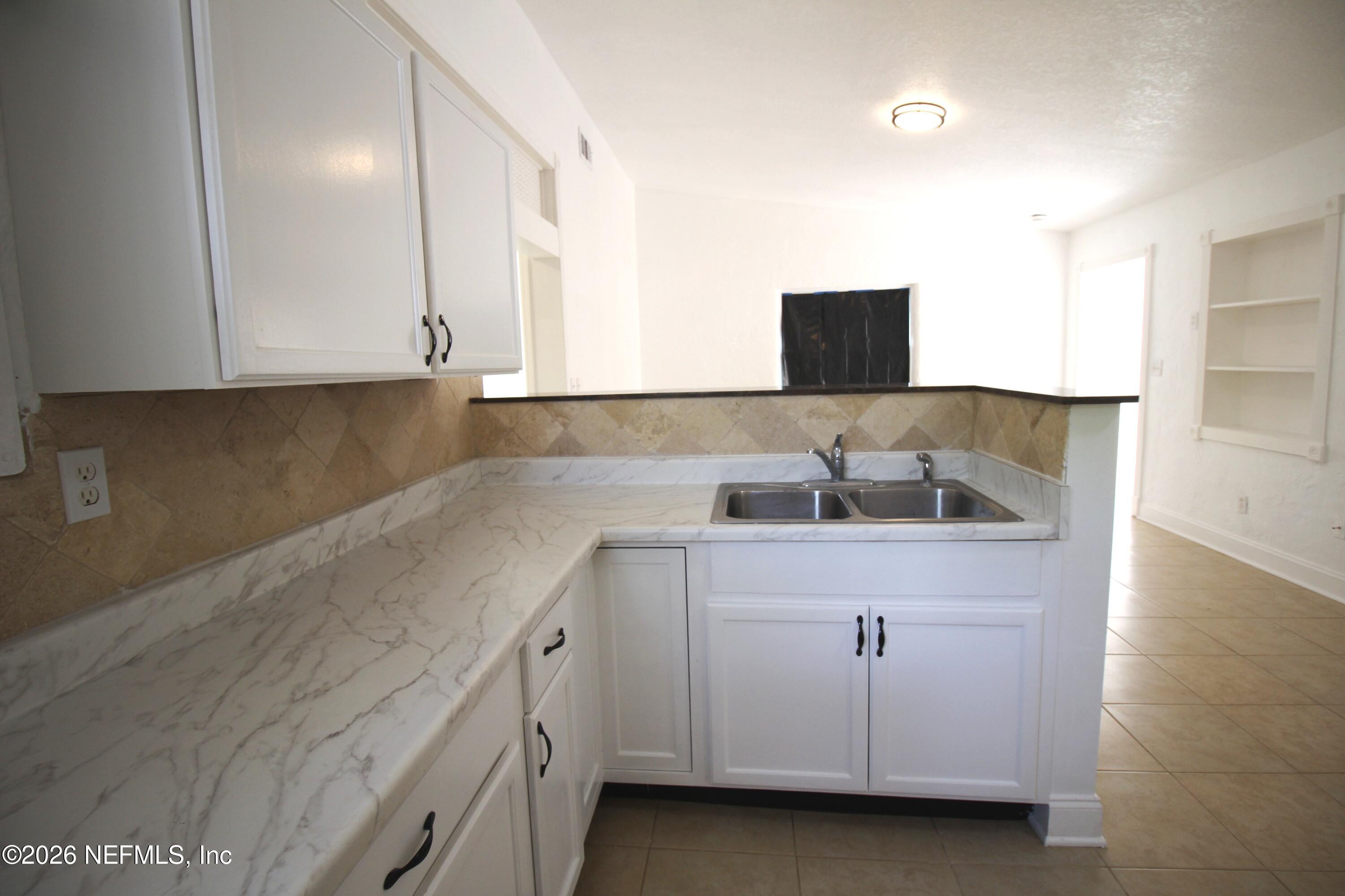 1304 King Arthur Road Jacksonville, FL 32211 - Photo 12 of 25 a view of cabinets and window