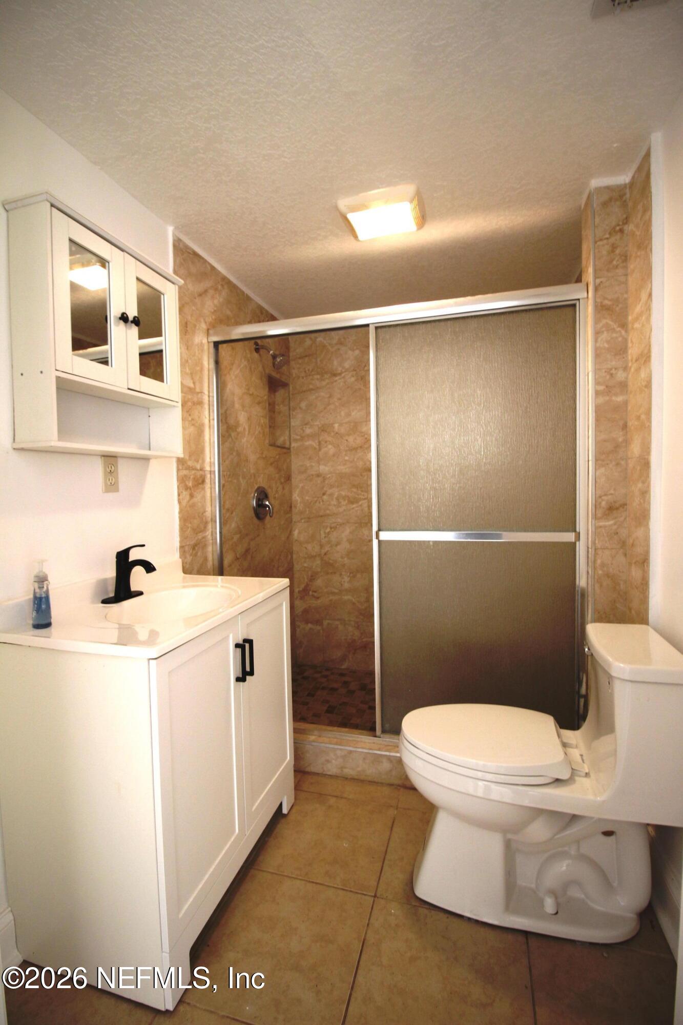 1304 King Arthur Road Jacksonville, FL 32211 - Photo 16 of 25 a bathroom with a sink a toilet and shower
