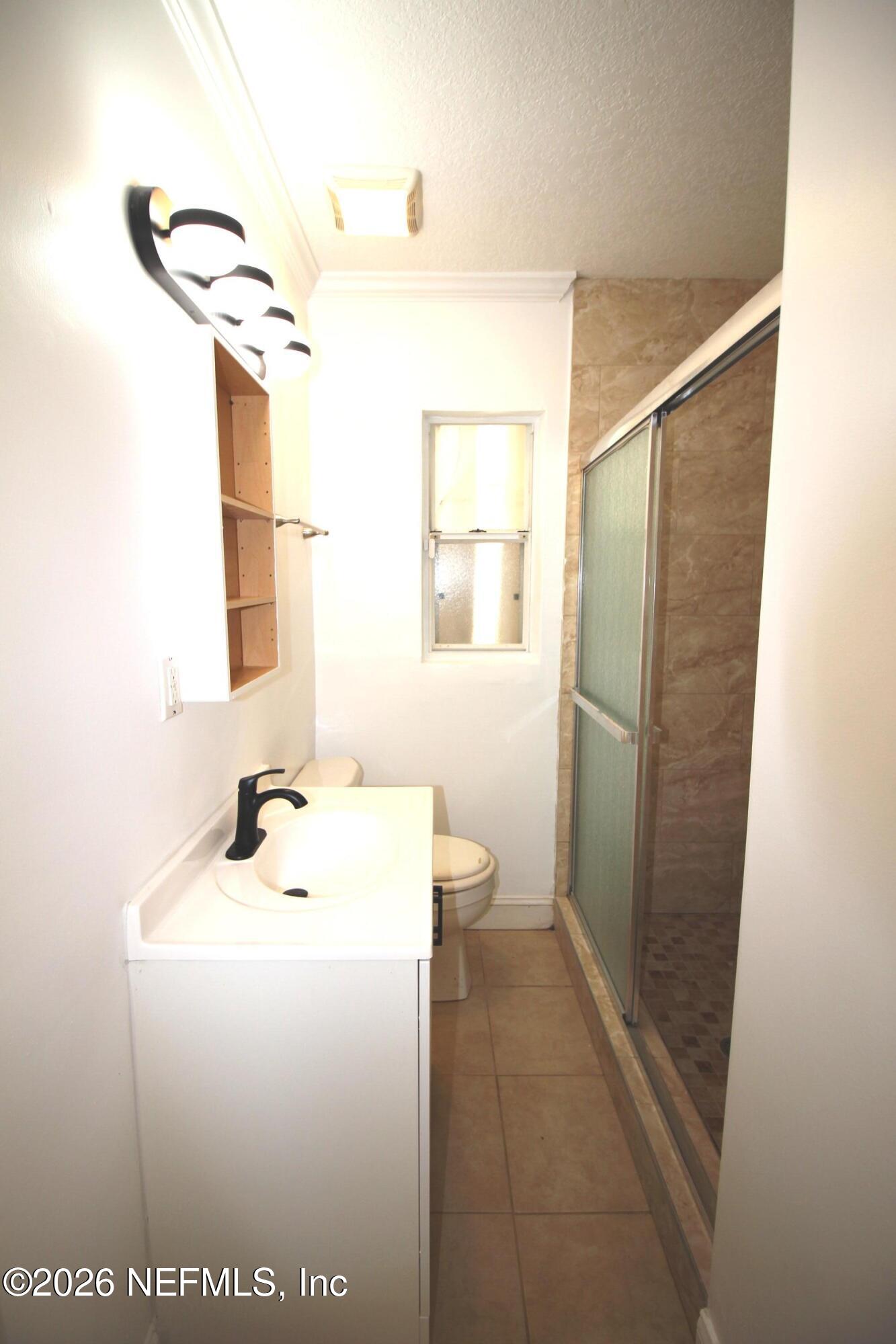 1304 King Arthur Road Jacksonville, FL 32211 - Photo 21 of 25 a bathroom with a sink and a mirror