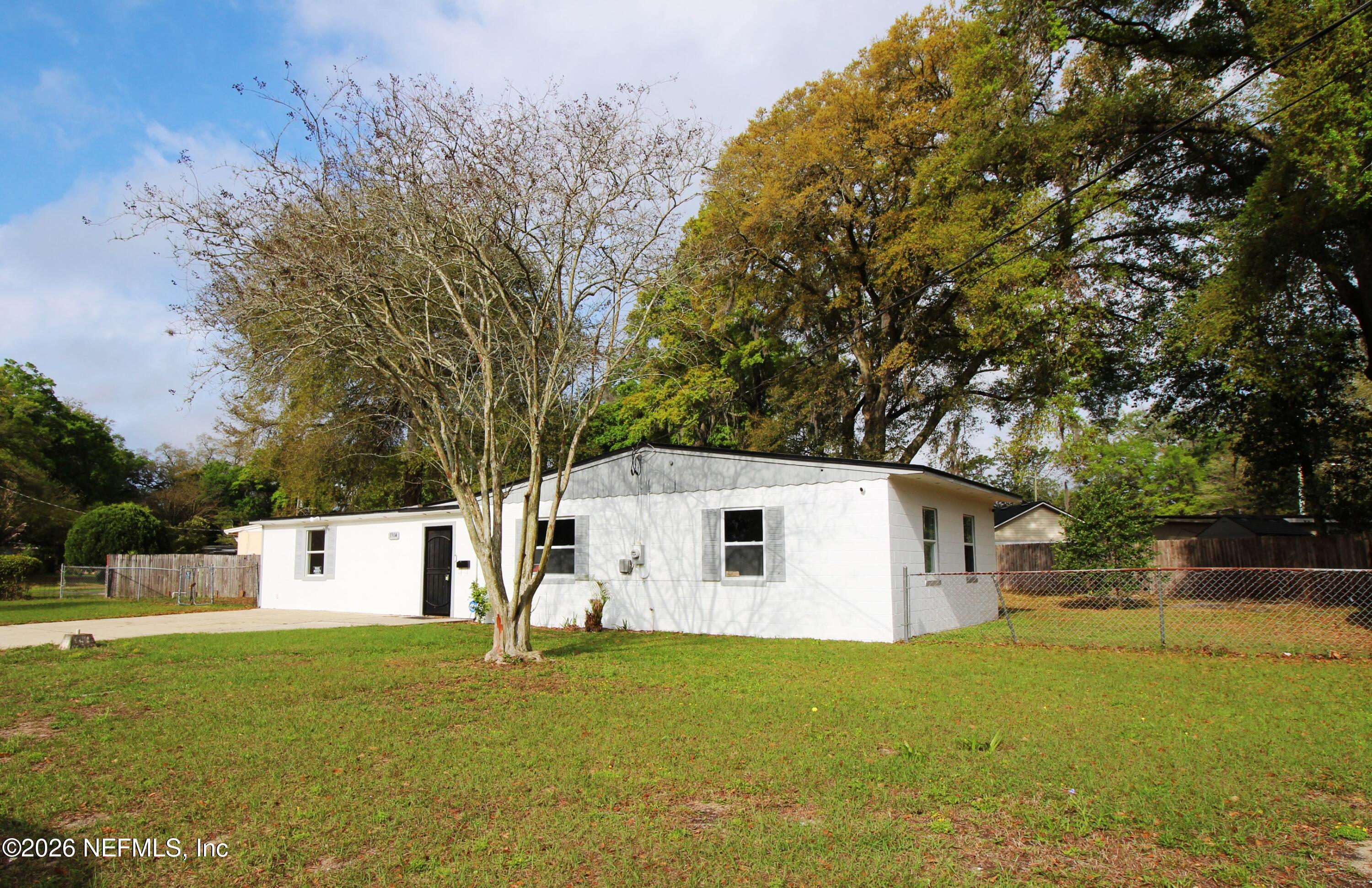 1304 King Arthur Road Jacksonville, FL 32211 - Photo 3 of 25 a view of a white house with a big yard