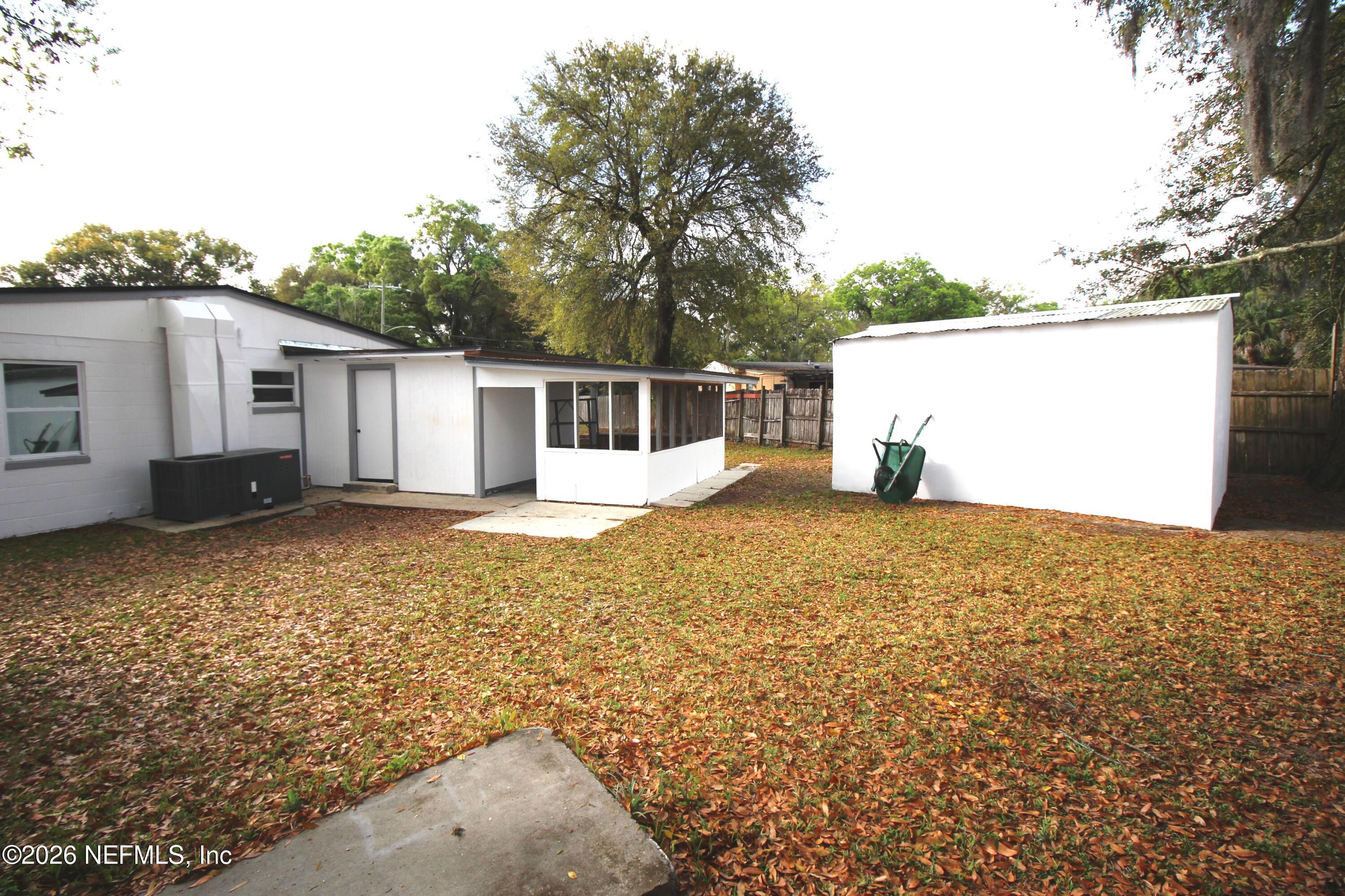 1304 King Arthur Road Jacksonville, FL 32211 - Photo 6 of 25 a backyard of a house with lots of green space