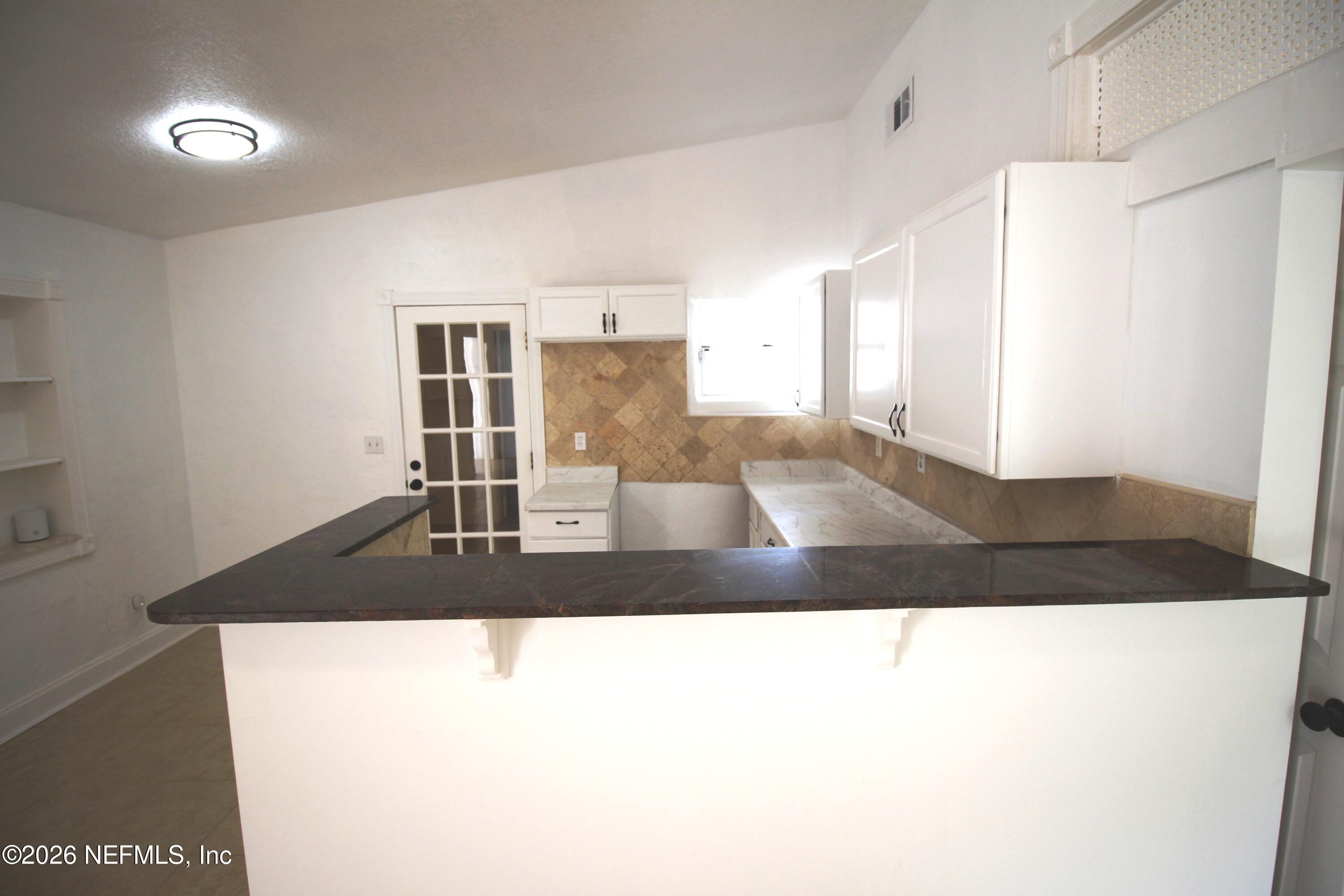 1304 King Arthur Road Jacksonville, FL 32211 - Photo 9 of 25 a living room with a black coffee table