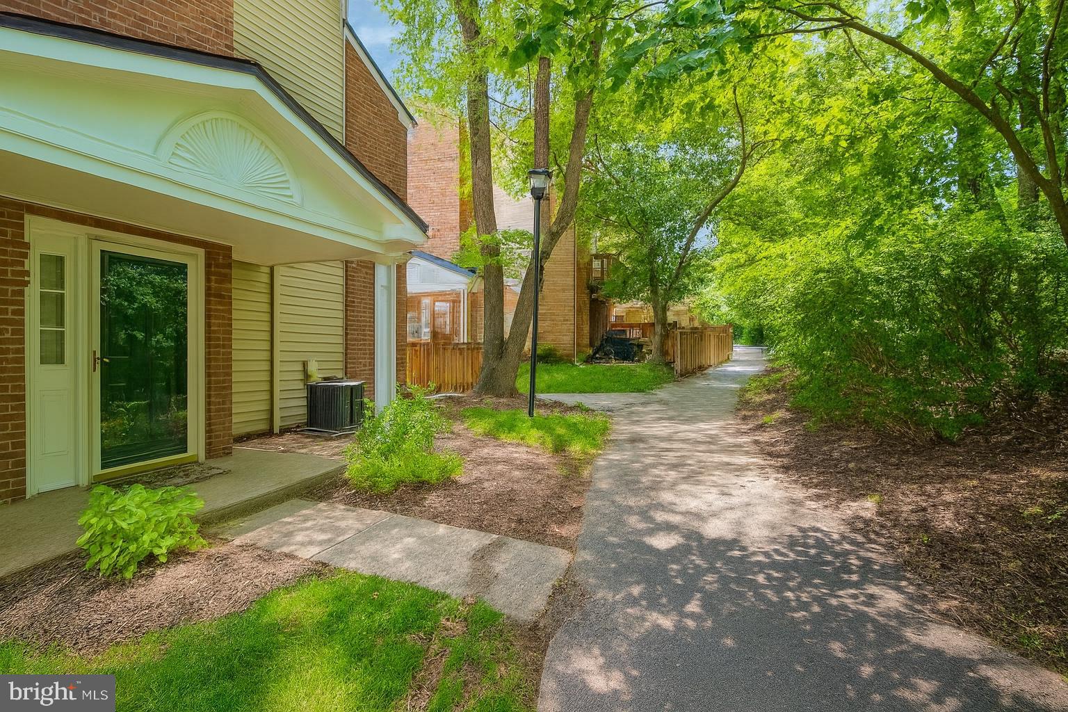 4165 Churchman Way Woodbridge, VA 22192 - Photo 1 of 31 Serene pathway through lush greenery.