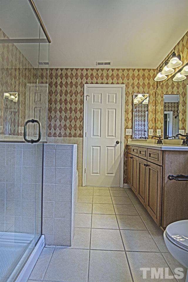 7120 Lowell Ridge Road Raleigh, NC 27616 - Photo 13 of 19 a bathroom with a sink a toilet and mirror