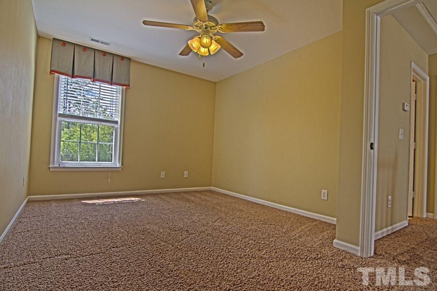 7120 Lowell Ridge Road Raleigh, NC 27616 - Photo 16 of 19 a view of an empty room with window and chandelier fan