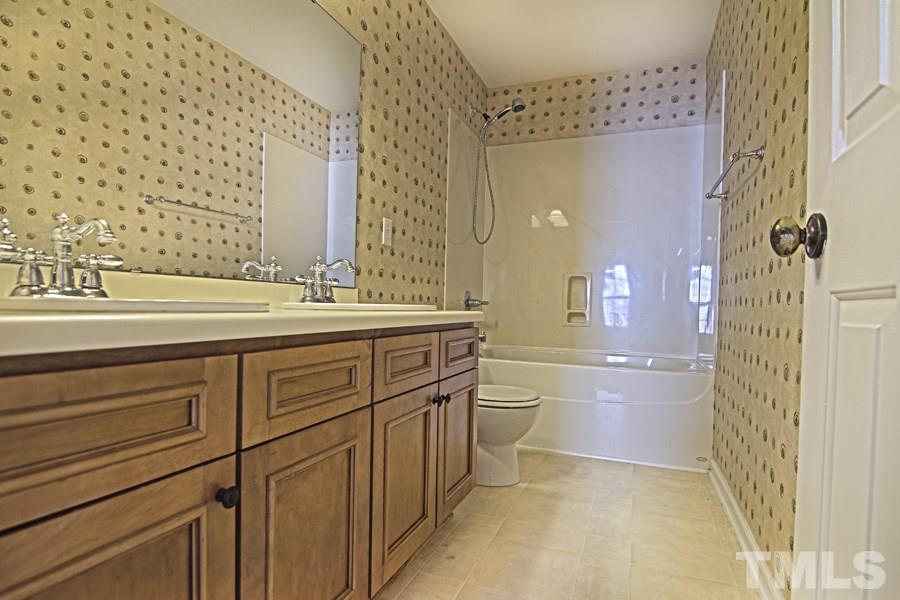 7120 Lowell Ridge Road Raleigh, NC 27616 - Photo 17 of 19 a bathroom with a sink a toilet and shower