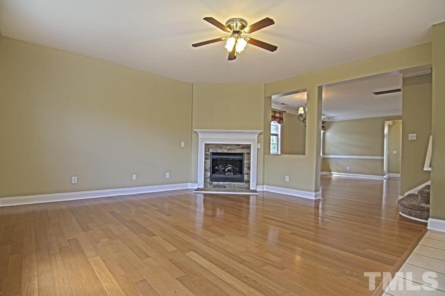 7120 Lowell Ridge Road Raleigh, NC 27616 - Photo 6 of 19 wooden floor in an empty room with a fireplace