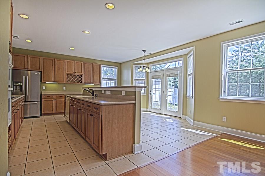 7120 Lowell Ridge Road Raleigh, NC 27616 - Photo 7 of 19 a kitchen with stainless steel appliances granite countertop a stove top oven sink and cabinets