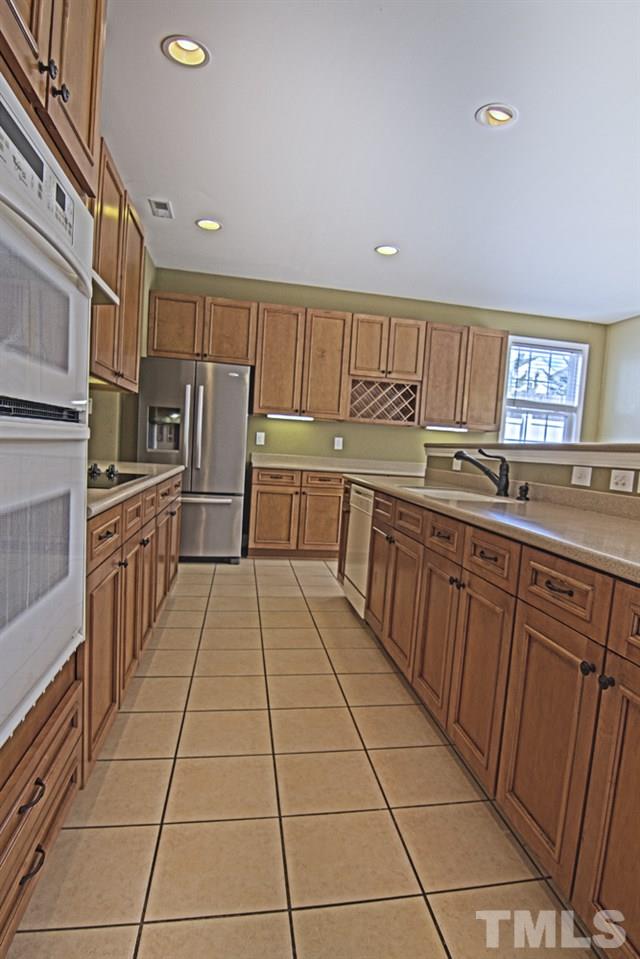 7120 Lowell Ridge Road Raleigh, NC 27616 - Photo 10 of 19 a kitchen with stainless steel appliances granite countertop a refrigerator and a sink