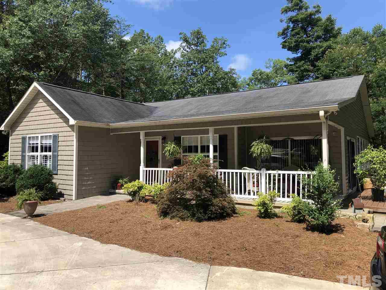 1125 Harris Mill Road Rougemont, NC 27572 - Photo 1 of 4 a front view of a house with a garden