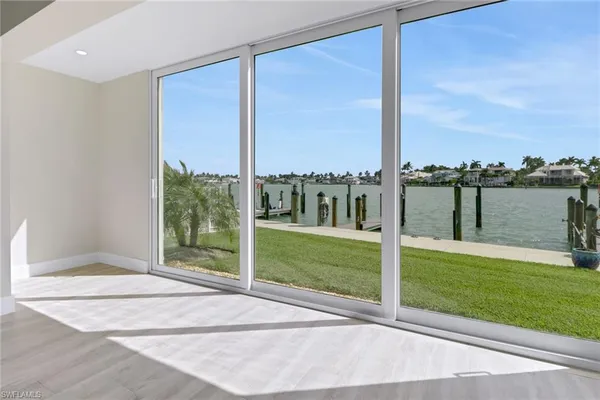 a view of a balcony with floor to ceiling windows with yard