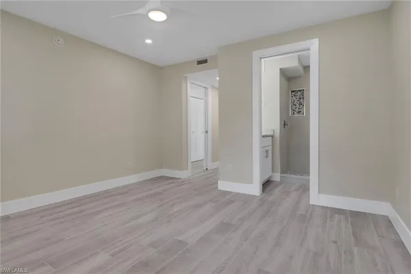 a view of a hallway with wooden floor