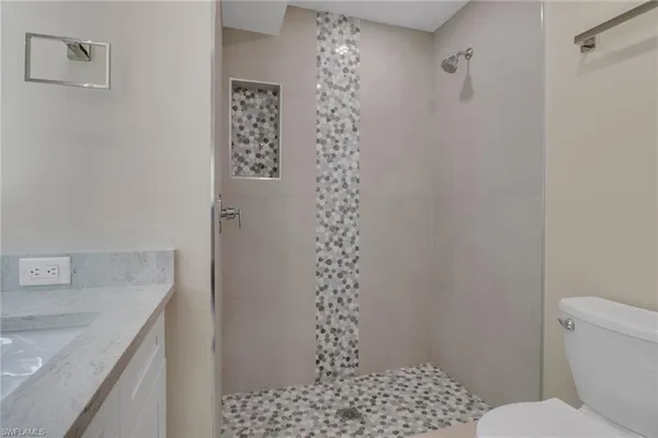 a bathroom with a sink toilet and shower