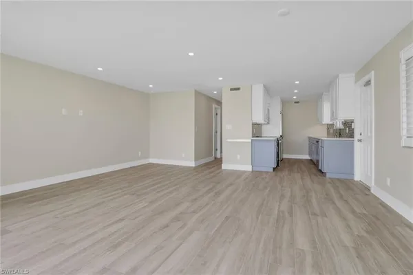 a view of a kitchen with a sink and wooden floor