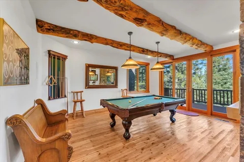 a living room with furniture a table and wooden floor