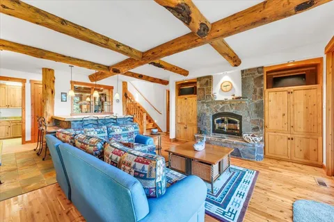 a living room with patio furniture and a fireplace