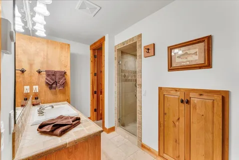 a bedroom with a bed and a dresser next to a window
