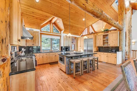 a kitchen with stainless steel appliances a stove a sink and a refrigerator