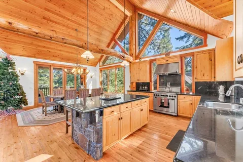 a view of a kitchen with kitchen island a large window in it