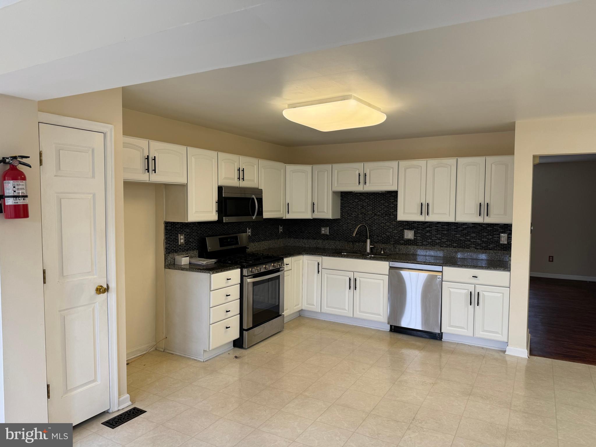 1002 Carlisle Road Egg Harbor Township, NJ 08234 - Photo 11 of 32 a kitchen with stainless steel appliances granite countertop a stove a sink and a refrigerator