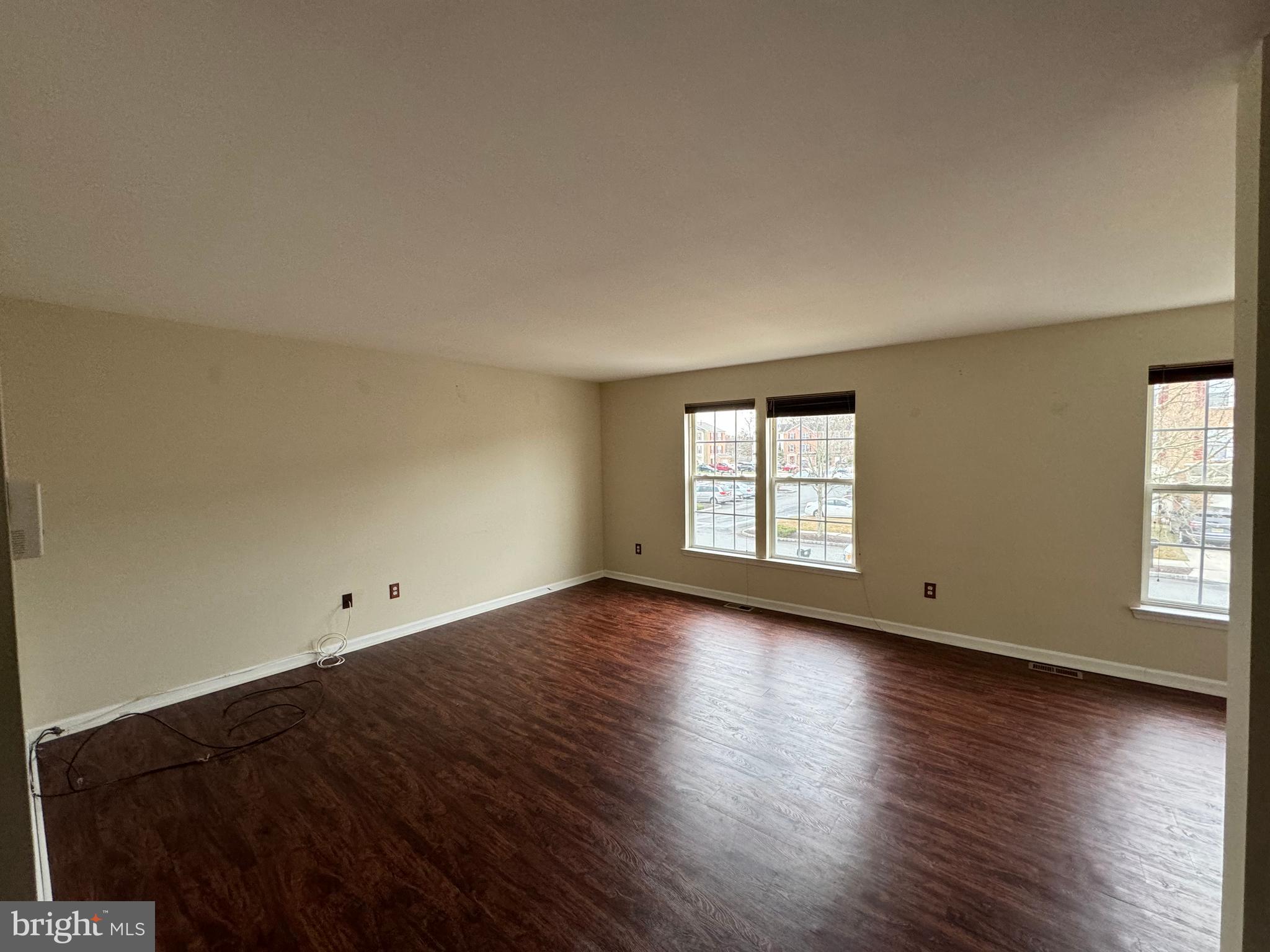 1002 Carlisle Road Egg Harbor Township, NJ 08234 - Photo 14 of 32 an empty room with wooden floor and windows