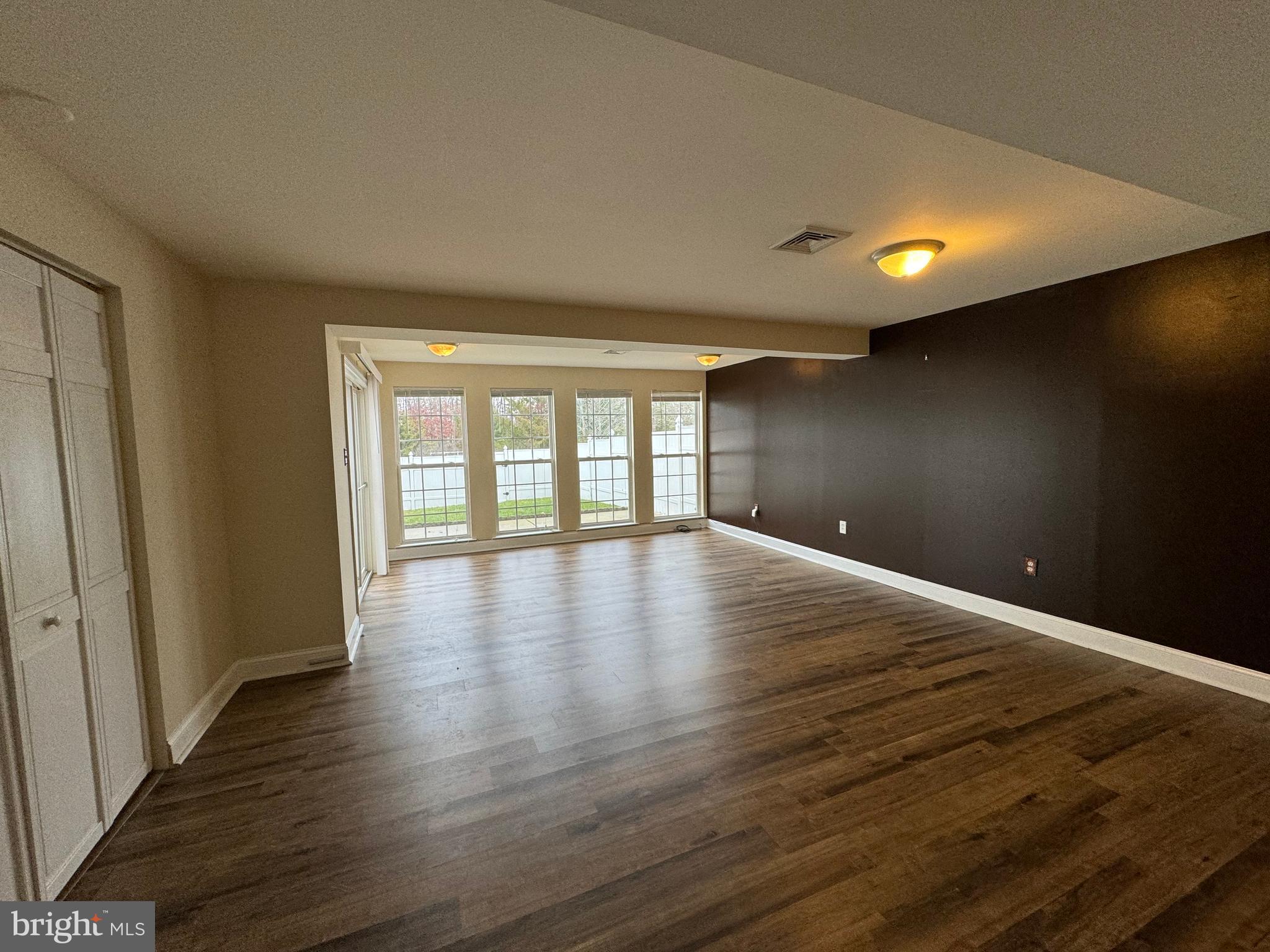 1002 Carlisle Road Egg Harbor Township, NJ 08234 - Photo 17 of 32 wooden floor in an empty room with a window