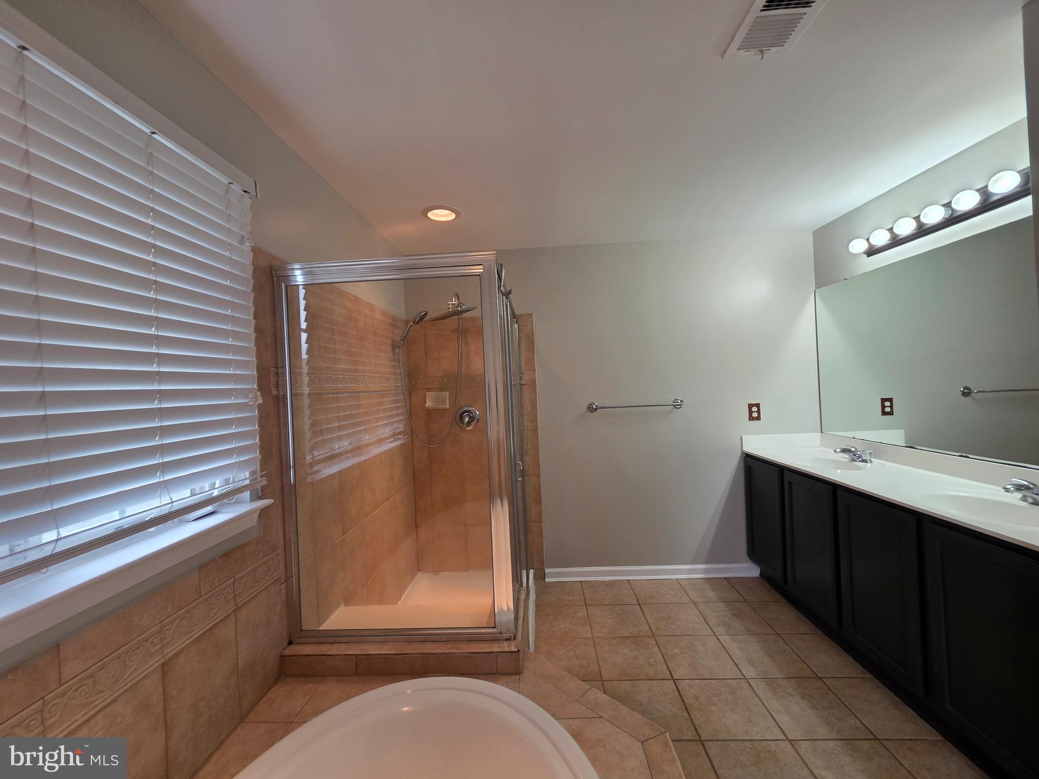 1002 Carlisle Road Egg Harbor Township, NJ 08234 - Photo 19 of 32 a bathroom with a shower sink and mirror