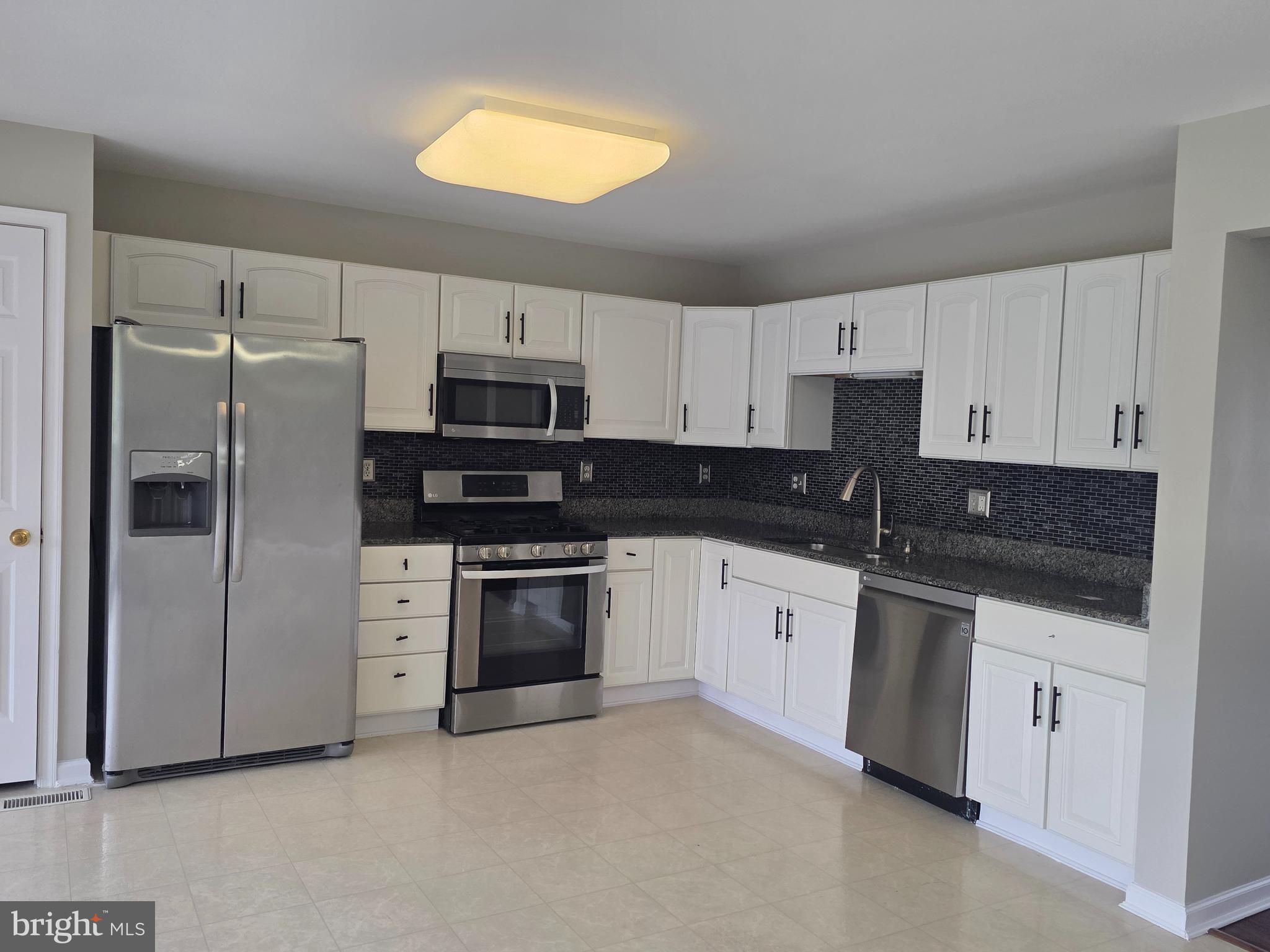 1002 Carlisle Road Egg Harbor Township, NJ 08234 - Photo 2 of 32 a kitchen with stainless steel appliances granite countertop a stove a sink and a refrigerator