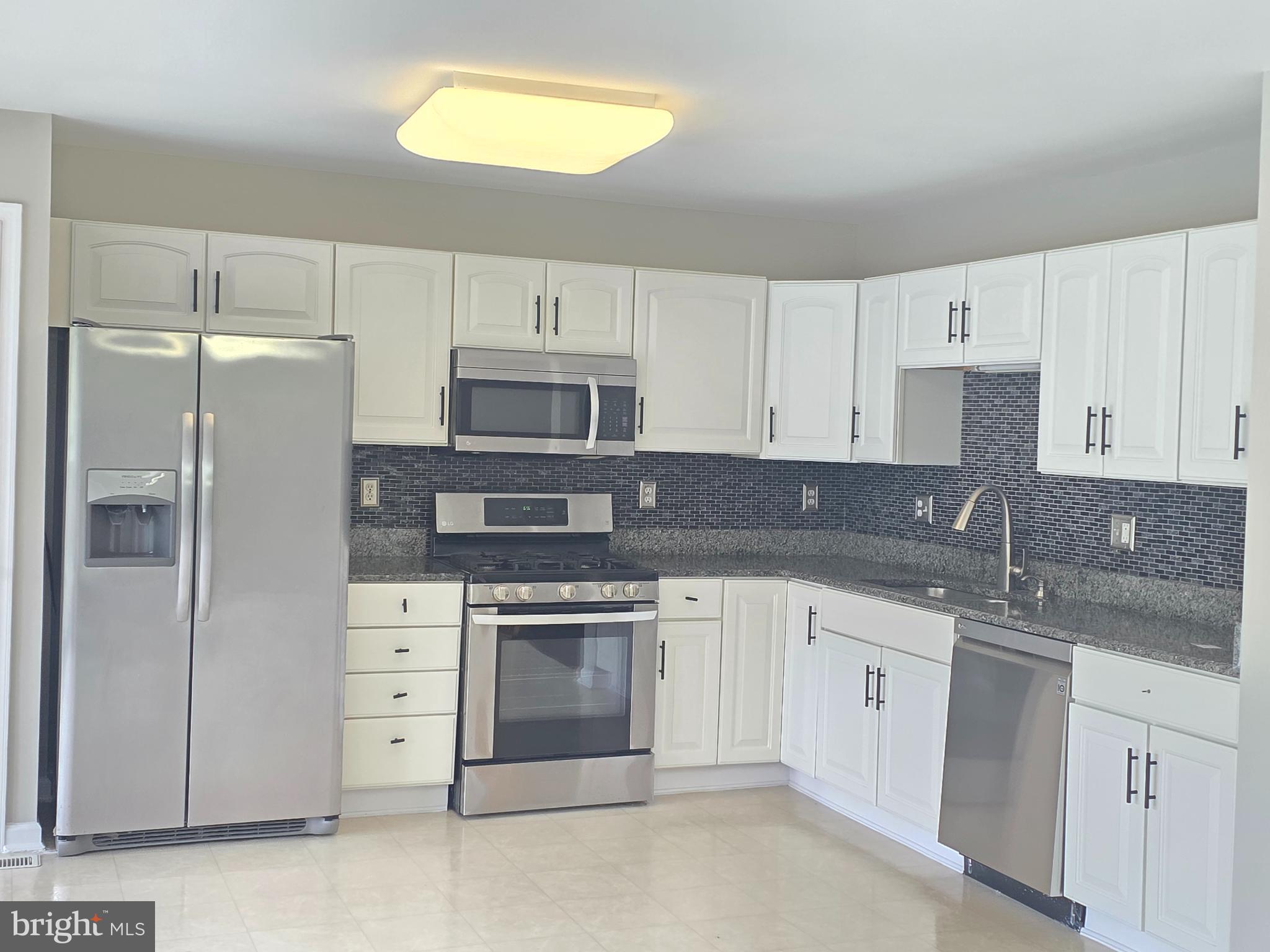 1002 Carlisle Road Egg Harbor Township, NJ 08234 - Photo 27 of 32 a kitchen with stainless steel appliances granite countertop a sink stove and refrigerator