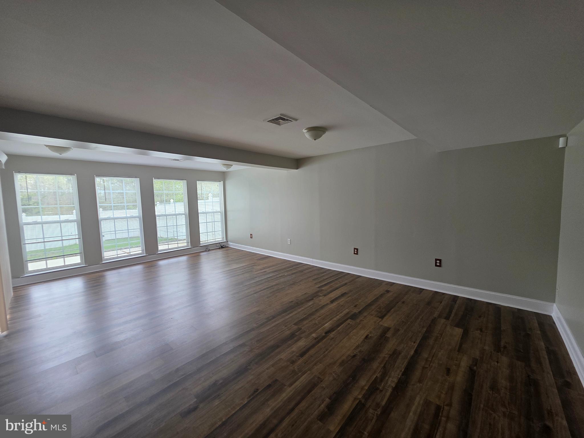 1002 Carlisle Road Egg Harbor Township, NJ 08234 - Photo 30 of 32 wooden floor in an empty room with a window