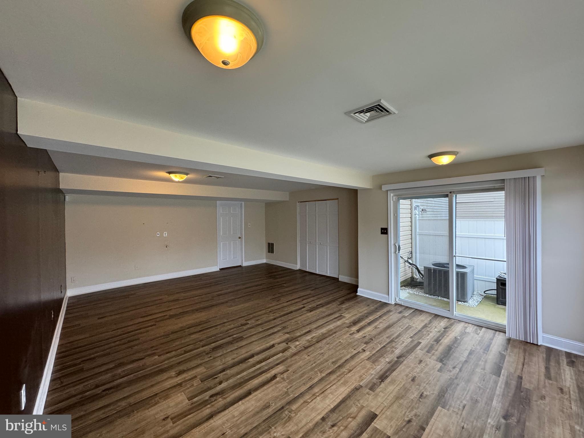 1002 Carlisle Road Egg Harbor Township, NJ 08234 - Photo 9 of 32 wooden floor in an empty room with a window