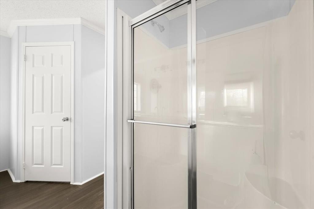 109 Summers Circle Azle, TX 76020 - Photo 18 of 32 a bathroom with a glass shower door