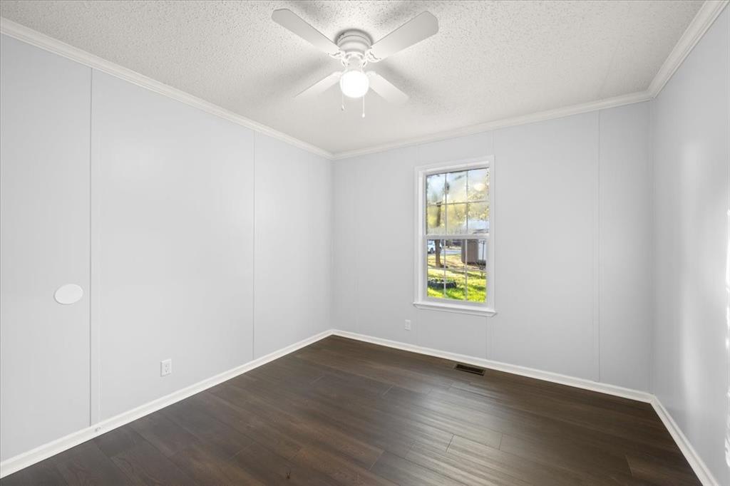 109 Summers Circle Azle, TX 76020 - Photo 20 of 32 a view of an empty room with window and wooden floor